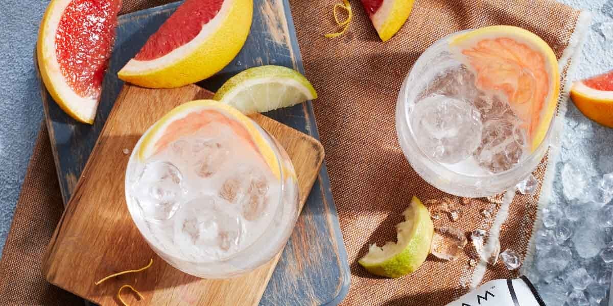 Two fizzy gin cocktails to get your taste buds tingling: a Grapefruit Fizz and a Strawberry & Lychee Highball!