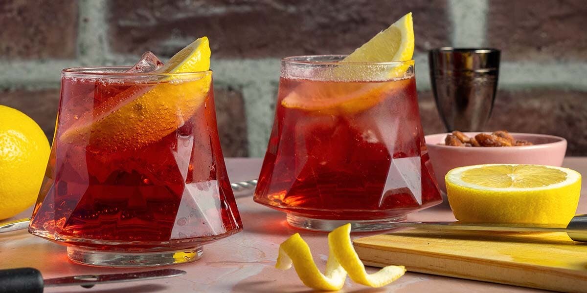 Enjoy a Cherry Bakewell Spritz cocktail with our gin-spiked Cherry Bakewell Tarts!