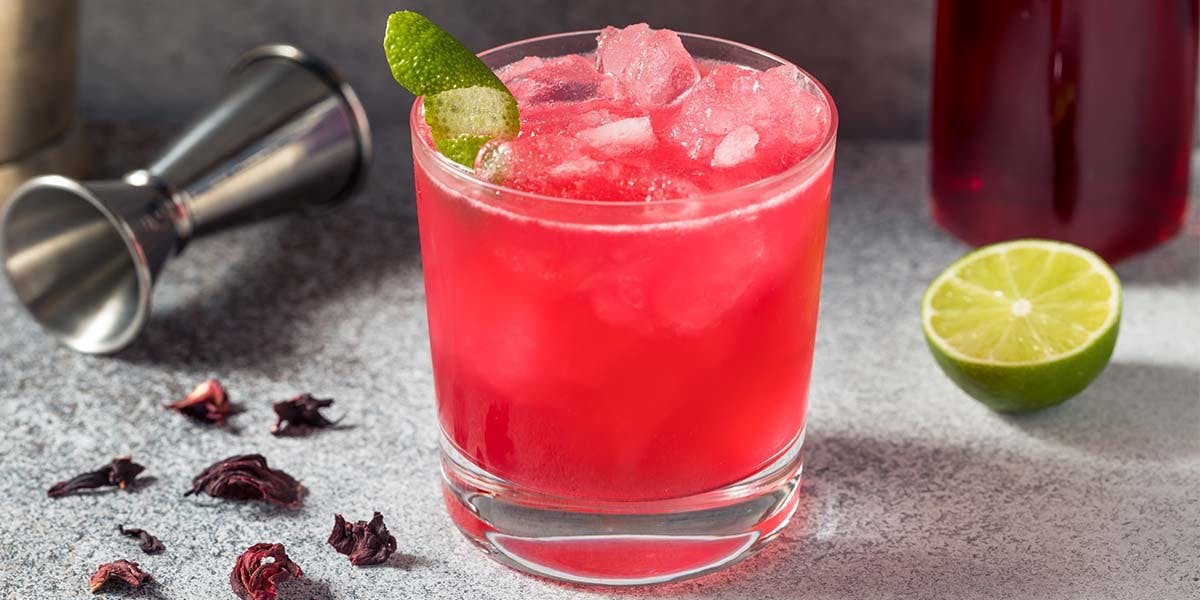 This bright red gin cocktail is made with hibiscus syrup and citrus ju ...
